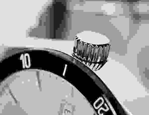 A close up of the time setting on a watch