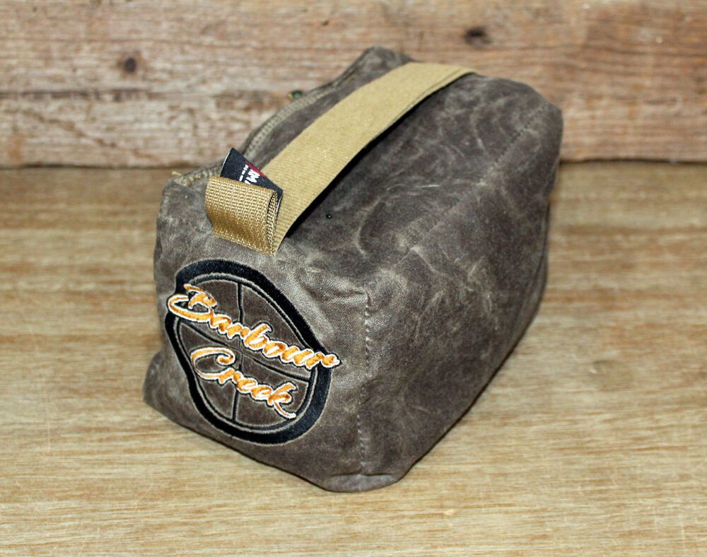 A small brown bag sitting on top of a wooden table.